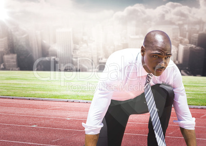 Business man on start line against skyline with clouds and flare