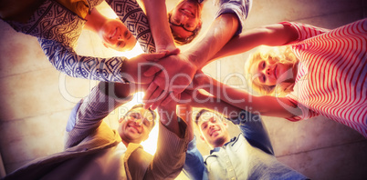 Portrait of happy business team joining hands