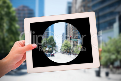 Composite image of masculine hand holding tablet