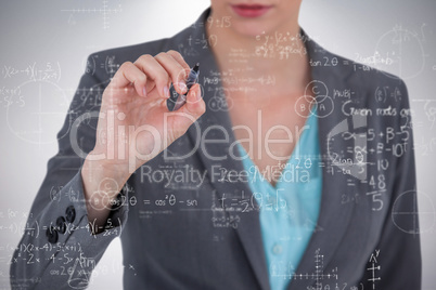 Composite image of businesswoman using invisible digital screen