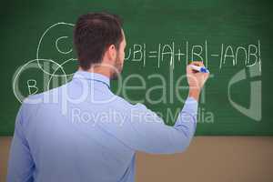 Composite image of rear view of a businessman writing with marker