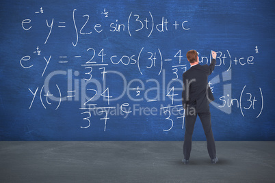 Composite image of rear view businessman writing with chalk