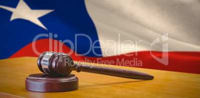 Composite image of close up of gavel on table