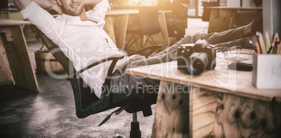 Smiling businessman relaxing on the chair
