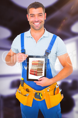 Composite image of happy repairman in overalls holding digital tablet