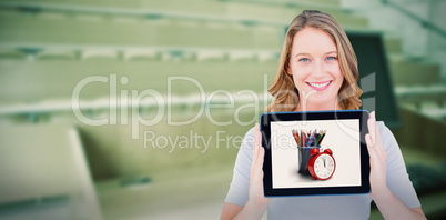 Composite image of portrait of happy woman showing digital tablet