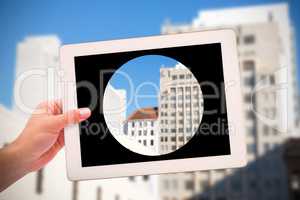 Composite image of masculine hand holding tablet