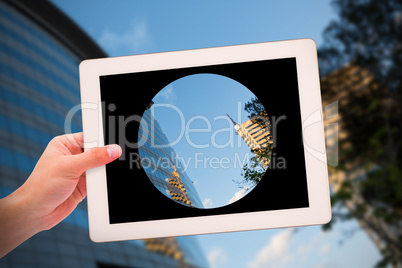 Composite image of masculine hand holding tablet