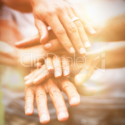 Happy volunteer family putting their hands together