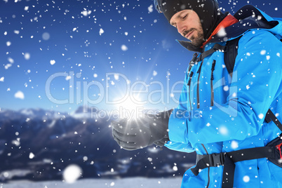 Composite image of skier with backpack wearing gloves