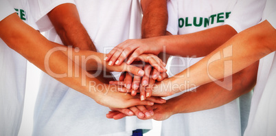 Group of volunteers putting hands together