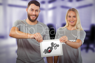 Composite image of smiling volunteers holding digital tablet