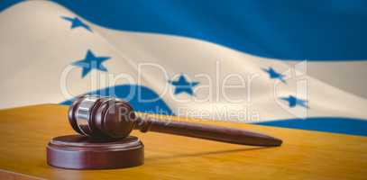 Composite image of close up of gavel on table