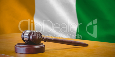 Composite image of close up of gavel on table