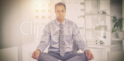 Businessman meditating on table