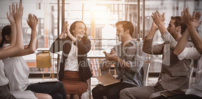 Business executives applauding after presentation