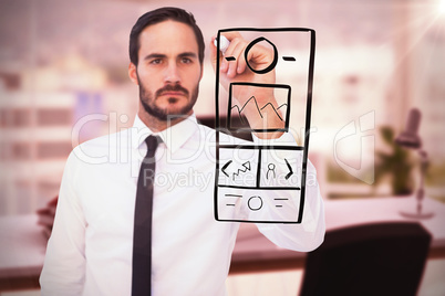 Composite image of focused businessman writing with marker