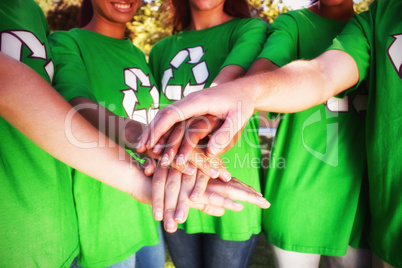 Midsection of volunteers stacking hands