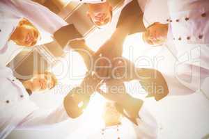 Chefs joining hands in a circle