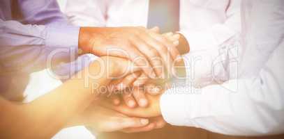 Close-up of coworkers stacking hands