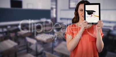 Composite image of beautiful woman holding digital tablet in front of her face
