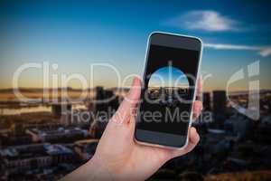 Composite image of hand holding mobile phone against white background
