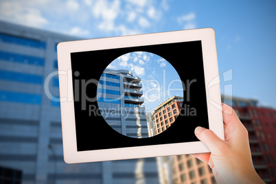 Composite image of masculine hand holding tablet