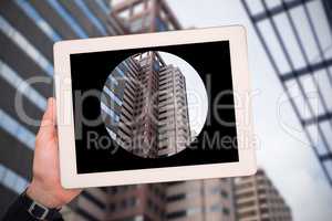 Composite image of masculine hand holding tablet