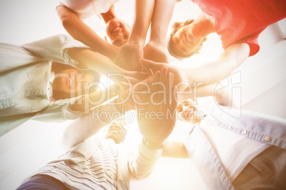 Portrait of smiling business people stacking hands