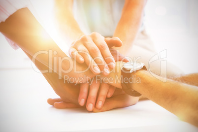 Close-up of colleagues stacking hands
