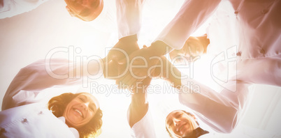 Portrait of chefs team stacking hands together