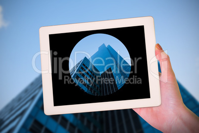 Composite image of feminine hand holding tablet