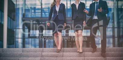 Businesspeople climbing down steps
