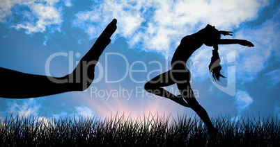 Composite image of side view of a sporty young woman stretching