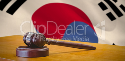 Composite image of close up of gavel on table