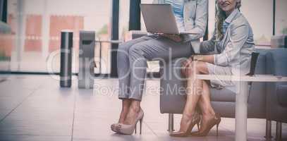 Businesswomen sitting with laptop
