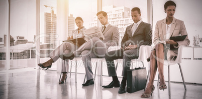 Well dressed business people sitting together