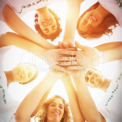 Smiling group of volunteers stacking hands