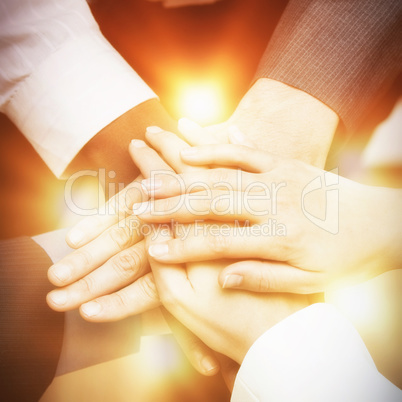 Colleagues stacking hands