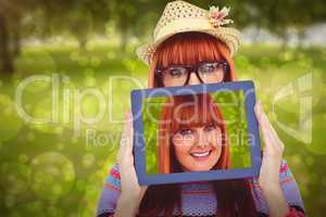 Composite image of attractive hipster woman behind a tablet