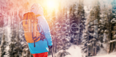 Composite image of rear view of skier holding ski pole