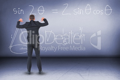 Composite image of businessman standing with hands up
