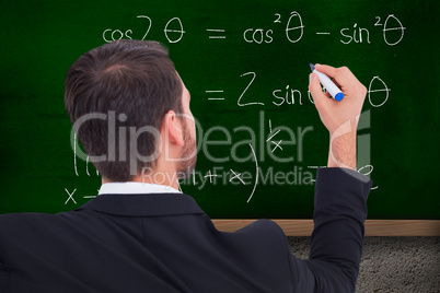 Composite image of rear view of businessman writing with marker