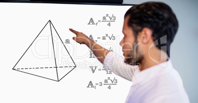 Man pointing over geometric shape by formulas on board