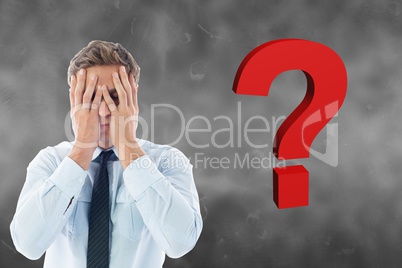 Confused businessman by question mark