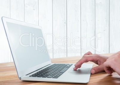 Hands on laptop with against wood