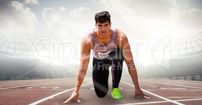 Digitally generated image of male athlete at starting point on racing track