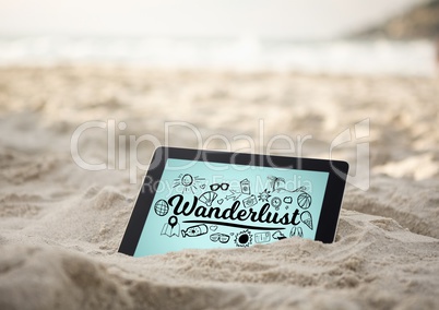 Tablet in sand with black wanderlust doodles against blue background
