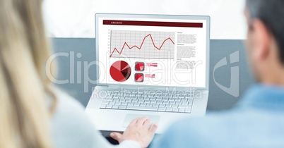 Business people analyzing graphs on laptop at desk