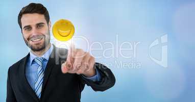 Business man touching emoji and flare against blue background
